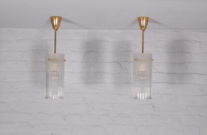 Pair of glass and brass suspensions.