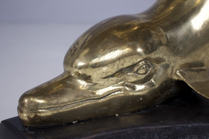 Feet of consoles with dolphins in solid brass.