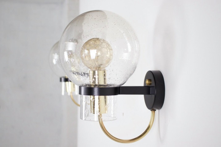 Wall lights with blown glass globes .