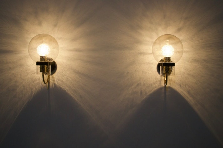 Wall lights with blown glass globes .