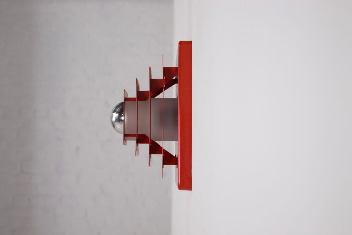 Red kinetic wall lamp.