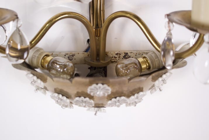 Brass floral sconce with pendants.