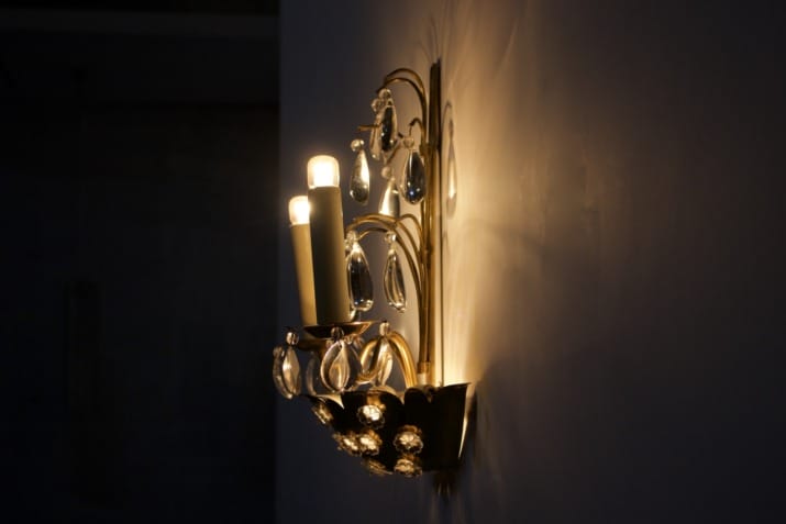 Brass floral sconce with pendants.