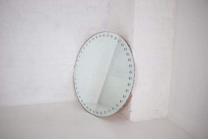 Large Fornasetti-style optical mirror.