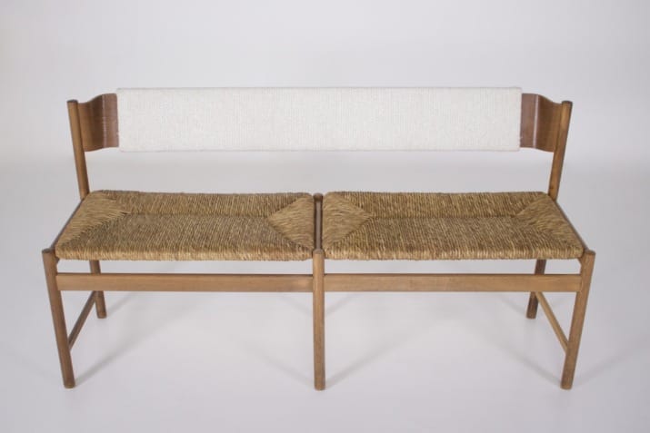 Modernist bench, straw-covered seat.
