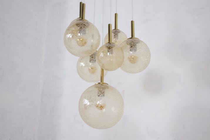 Cascade" brass chandelier with amber globes